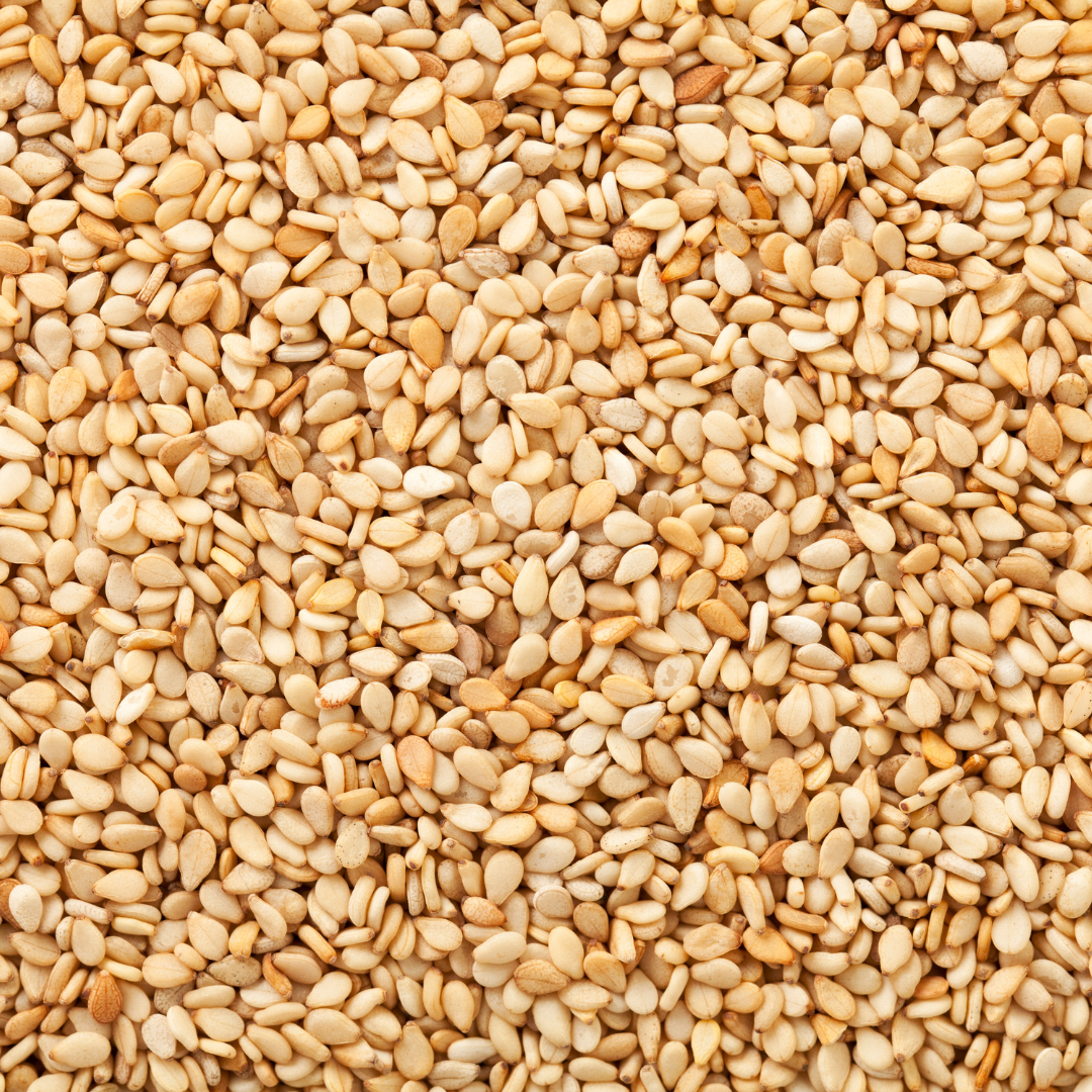 Close-up of golden sesame seeds showcasing their natural texture.